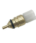 Engine coolant temperature sensor, brass body with white plastic connector, close-up