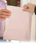 Hands holding Khaki Waterproof Mailing Envelopes With Strong Adhesive For Clothes And Cosmetics, Tear-Resistant Packing Mailers.