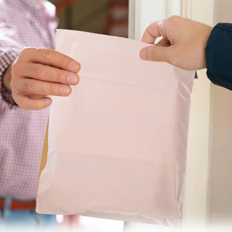 Hands holding Khaki Waterproof Mailing Envelopes With Strong Adhesive For Clothes And Cosmetics, Tear-Resistant Packing Mailers.