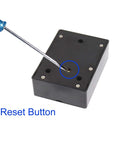 Back view of Hidden RFID Electronic Cabinet Lock For Wooden Cabinets, Drawers, And Cupboards, with a screwdriver on the reset button.