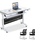 Top Shelf Flip Top Mobile Training Table And Two Chair Set With Dead Simple Folding Operation Tough Rolling Casters Smart Storage Tray And Modesty Shield For Active Rooms, white laminate table with laptop and two black mesh chairs.