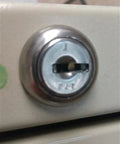 Close-up of a filing cabinet lock, highlighting custom cut file cabinet and cubicle desk replacement key that goes like a charm.