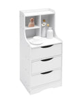 White vertical bedside cabinet with three drawers and open storage shelf showcasing decor items, ideal for lamps and books in bedroom.