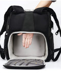 Person demonstrating storage of Big Capacity Laptop And DSLR Video Camera Backpack With All Weather Cover, open and empty interior visible