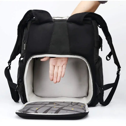 Person demonstrating storage of Big Capacity Laptop And DSLR Video Camera Backpack With All Weather Cover, open and empty interior visible