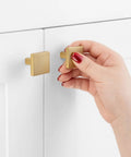 Person installing 10 Pack 1-1/8 Inch Square Brushed Gold Cabinet Knobs And Pulls Set For Cabinets And Drawers Heavy Duty Solid Metal Hardware