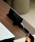 Upgrade Your Home Office Setup With This Smooth Riding Mobile Standing Desk That Dials In Your Perfect Height Fast For Seamless Sit Or Stand Flexibility Wherever You Roll. Phone resting in cable management slot on wooden desk.