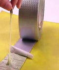 2 Pack Butyl Rubber Aluminum Foil Sealant Tape 5cm By 5m Weatherproof Waterproof Leak Repair shown being unwound with adhesive exposed
