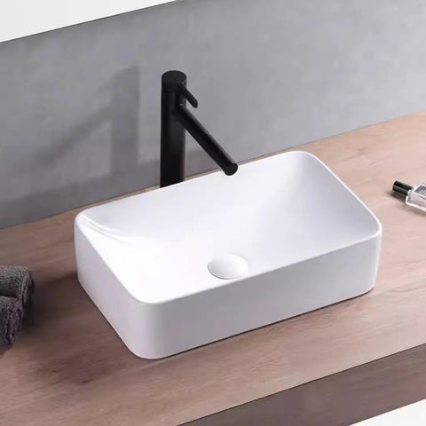 USZWBY Vessel Sinks Modern Minimalist Table Basin On The Counter Rectangular Washbasin Ceramic Art Bathroom Bowl Sink on wooden countertop with black faucet.