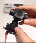 Rock Solid 4K AI Gimbal Camera For Rc Fpv Drones Packed With 6X Digital Zoom And Smart Motion Tracking held in hand.