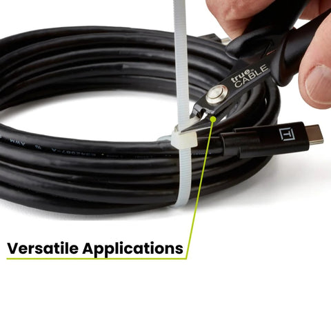 trueCABLE Precision Flush Cutter with black non-slip handle cutting a white zip tie around a coiled USB-C cable.