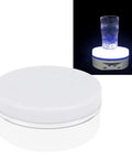Slick 6.3 Inch Electric Rotating Display Stand With LED Glow, Adjustable Speed Turntable displaying a glass.