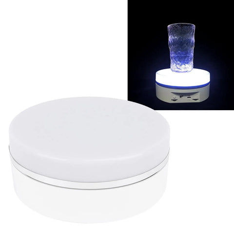 Slick 6.3 Inch Electric Rotating Display Stand With LED Glow, Adjustable Speed Turntable displaying a glass.