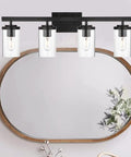 Brushed Brass 5 Light Farmhouse Vanity Lights With Clear Glass Shades, Modern Wall Sconce mounted above oval mirror
