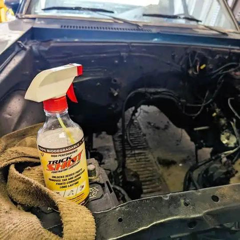 Bottle of 3 In 1 Penetrating Lubricant Oil Plant Based Biobased Food Grade Degreaser And Rust And Corrosion Remover in vehicle engine bay