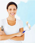 Woman holding a mini paint roller and brush smiling against a blue wall, showcasing 20 Pack Mini Paint Roller Kit With High Density Foam Covers For Snappy Spot Touch Ups And Crisp Trim Lines Delivers A Flat Coating That Truly Takes No Sweat Off Every DIY Home Refresh Job.