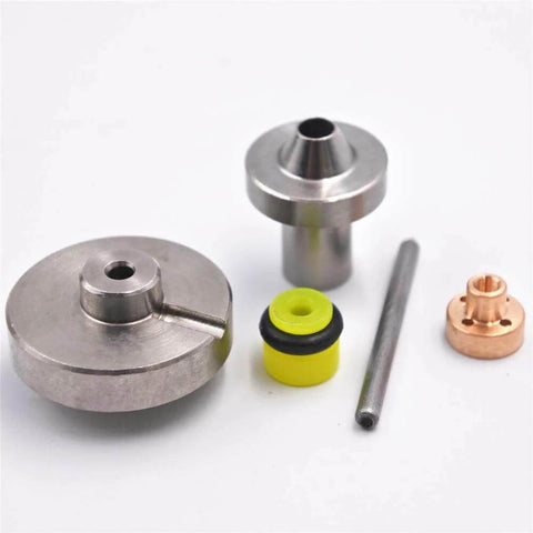 Seal kit for waterjet cutting machine; metal discs, cylindrical fittings, yellow rubber seal, copper fitting, and steel rod.