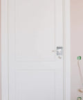 Front view of a door with a 4 Pieces Door Reinforcement Plate Set For Door Handle Fixing Cover Filler Backplate installed.