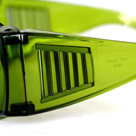 Close-up of Top Tier Laser Safety Goggles With Wide Spectrum Filtering And Slick Polycarbonate Frames, showcasing green tinted lenses.