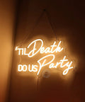 Til Death Do Us Party Neon Light Sign For Wedding Reception And Bridal Shower Backdrop Bedroom Wall Decor 17 Inch Warm White LED With USB Power And Dimmer Switch Ideal Birthday Gift And Romantic Home Decor glowing on wall.