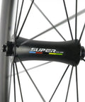 Close-up of Beast 700C Road Carbon Wheelset With 50mm Deep Section, 23mm Clincher, R7 Hub showing hub and spokes.