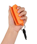 Hand holding Orange Archery Arrow Puller Gripper With Belt Clip Two Pack Grab And Go Soft Molded Handle Anti Skid Grip Keychain