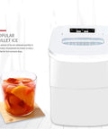 No Sweat Countertop Ice Cube Maker Delivers Fresh Cubes In Six Minutes Flat with clear front panel and glass of ice.