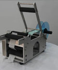 Semi Auto Round Bottle Labeling Machine For 15-30 Pcs Per Minute Speed with aluminum alloy frame and label rolls.