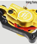 Close-up of Heavy Duty Hydraulic Disc Brake Set Front And Rear With Two Piston Aluminum Calipers, gold finish.