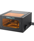 Creality laser engraver enclosure 2.0, front view, black metal body with orange-tinted front window and side vent