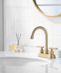 Gold 4 Inch Center Set Bathroom Faucet With Pop Up Drain, 2-Handle Sink Faucet, brushed gold finish on white sink with round mirror.