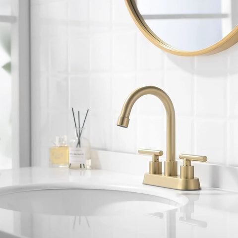 Gold 4 Inch Center Set Bathroom Faucet With Pop Up Drain, 2-Handle Sink Faucet, brushed gold finish on white sink with round mirror.