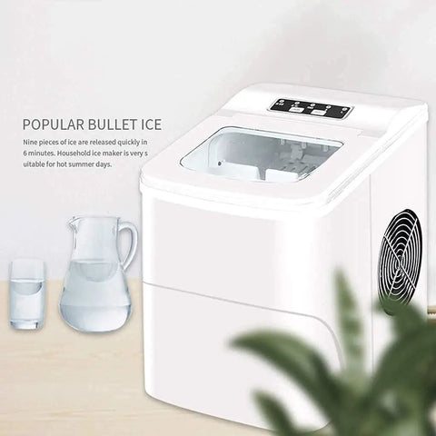 Compact Electric Ice Cube Maker Countertop Portable Machine That Blasts Ice In Six Minutes Flat With Ultra Quiet Operation, white ABS design, water pitcher nearby.
