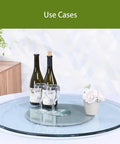 Round Glass Lazy Susan With Hella Sturdy Thickened Base For Dining Tables Heavy Duty Heat Resistant Serving Tray with wine bottles and glasses.