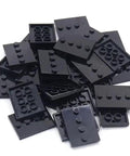 Pile of black 3x4 four-stud bracket plates from the Mini Figure Display Stand Set With 50 Pieces Classic Bracket Plate 3x4 Four Studs Compatible With Lego And Other Brick Brands Ideal For MOC Builds Figure Displays And Replacement Parts, showing multiple interlocking surfaces.