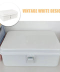 Heavy Duty Vintage White Metal Toolbox Featuring A Tight Snap Shut Locking Latch Tin Storage Case For Everyday Gear And Art Supplies Classic Secure Organizer Trunk on a desk.