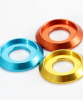 100-Piece Set of Badass M6 Titanium Gray Aluminum Grooved Washers Featuring a Sick Metallic Glow in blue, orange, and yellow.