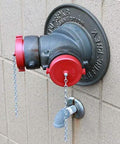 2 1/2 Inch NH NST Red Plastic FDC Plug With Rocker Lug Thermoplastic Not For Pressure Applications installed on hydrant