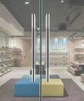 Stainless Steel Glass Door Handle For Indoor And Outdoor Use 80 By 50 Cm Tubular Sliding Door Hardware in showroom setting.