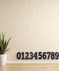 Six Sheets Black 4 Inch Outdoor Alphabet Decals Self Adhesive PVC Vinyl Letters For Signs Mailboxes And Dorm Doors Easy Peel And Stick Weatherproof Durable Outdoor Lettering Residue Free Repositioning DIY Ready black number decals on wall beside potted plant