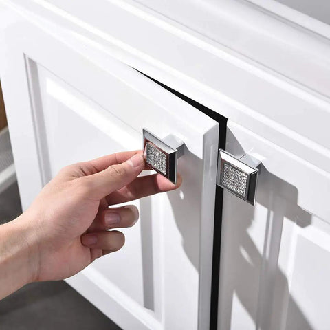 Hand installing Square Cabinet Handles And Crystal Knobs With All Metal Drawer Pulls Bling Bling Chrome Finish on white cabinet door