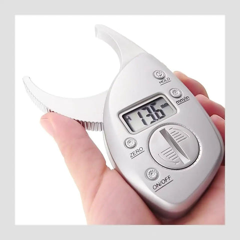Pinch And Read Digital Body Fat Caliper With LCD Display held in hand, showing measurement in millimeters on screen.