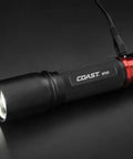 1000 Lumen Rechargeable Pure Beam LED Flashlight With Slide Focus Optic And Dual Power, black body on gray surface, charging