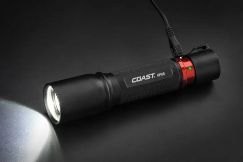 1000 Lumen Rechargeable Pure Beam LED Flashlight With Slide Focus Optic And Dual Power, black body on gray surface, charging