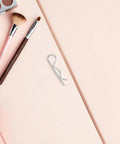 Premium Stainless Steel R Shape Industrial Pins For Secure Mechanical Assembly Plus Heavy Duty Fasteners on a pink background.