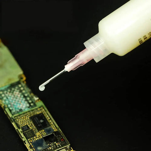 Solder Paste Booster Kit For Mobile Phone PCB BGA Reballing And Pro Grade Soldering Flux Set With Push Rod And Syringe Needle Booster Tool Halogen Free Aluminum Red in use on PCB with syringe.