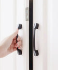 Hand opening door secured by Ultra Thin Magnetic Cabinet Catch For Doors 2 Pack No Nonsense Strong Hold 3.5mm Slim Latch.