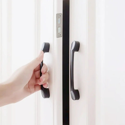 Hand opening door secured by Ultra Thin Magnetic Cabinet Catch For Doors 2 Pack No Nonsense Strong Hold 3.5mm Slim Latch.