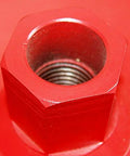 Red hexagonal metal core drill adapter with threaded inner bore.