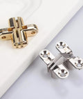 Hidden Cross Hinges For Doors 4 Pack 180 Degree Opening Stainless Steel Satin Finish Invisible Gate Hinges For Folding Doors Cabinets Chests And Wooden Boxes Vctitil, shown in gold and silver.